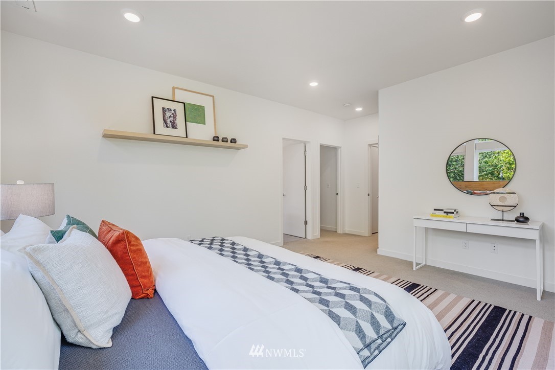 3217 East Spring Street Seattle, WA 98122 - Photo 15 of 33 a bedroom with a bed and a chandelier