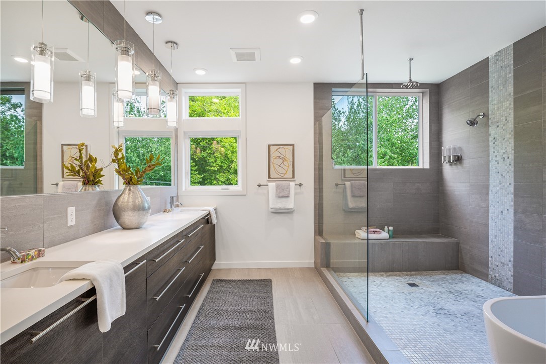 3217 East Spring Street Seattle, WA 98122 - Photo 18 of 33 a bathroom with a granite countertop tub sink and mirror