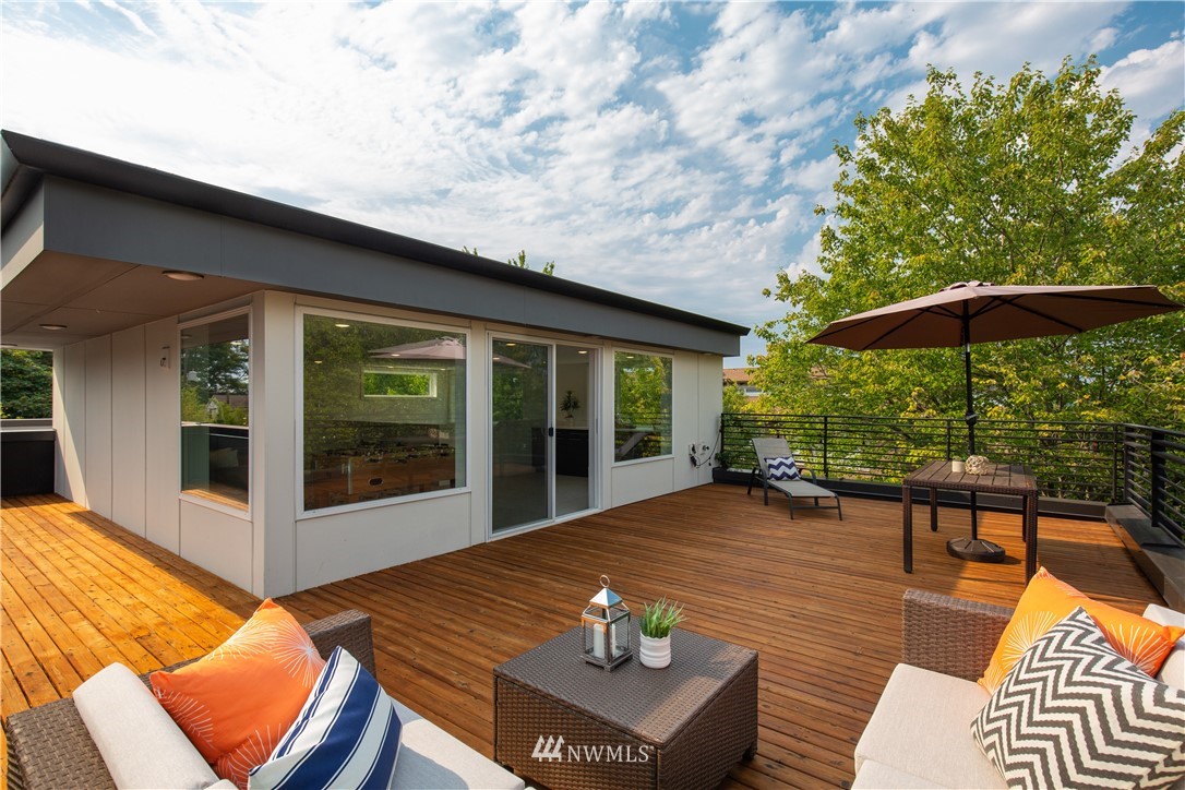 3217 East Spring Street Seattle, WA 98122 - Photo 28 of 33 a view of a patio with a table chairs and a yard