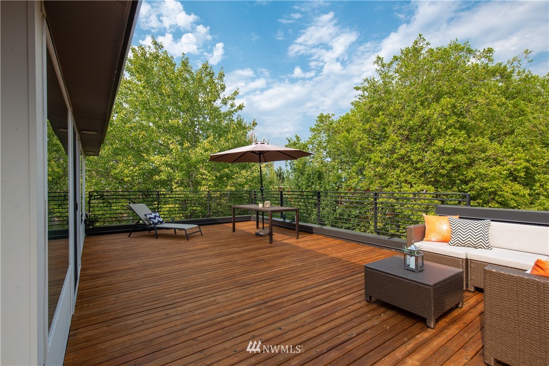 3217 East Spring Street Seattle, WA 98122 - Photo 29 of 33 a view of a chairs and table in the wooden deck