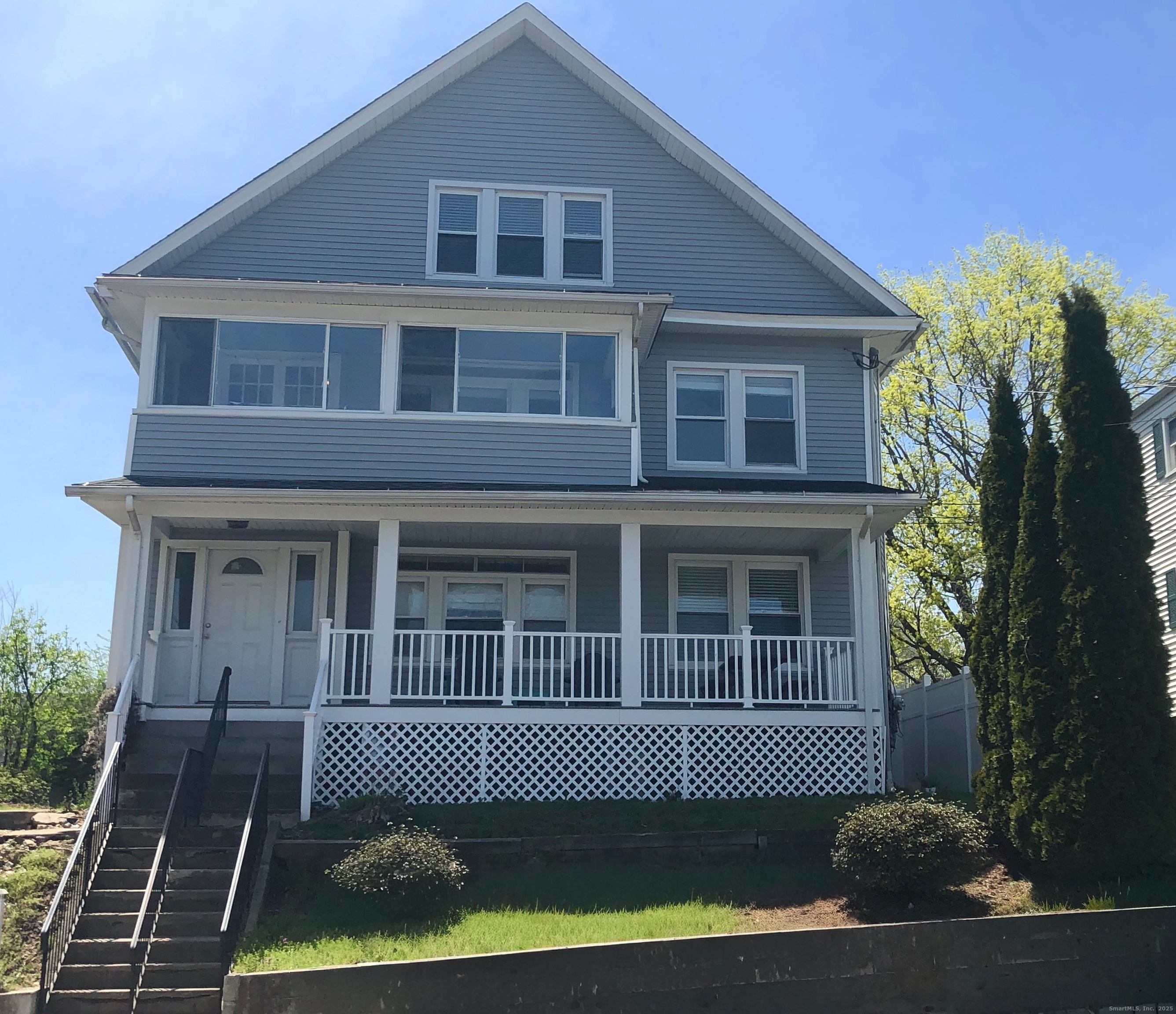 a front view of a house with a garden