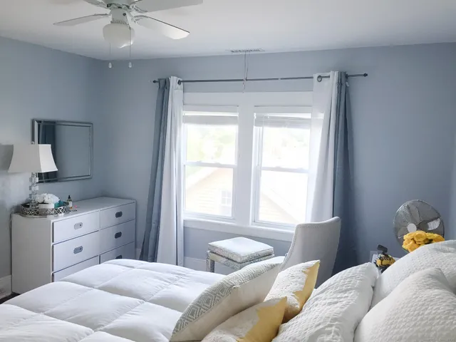 a view of a room that has a bed and a window
