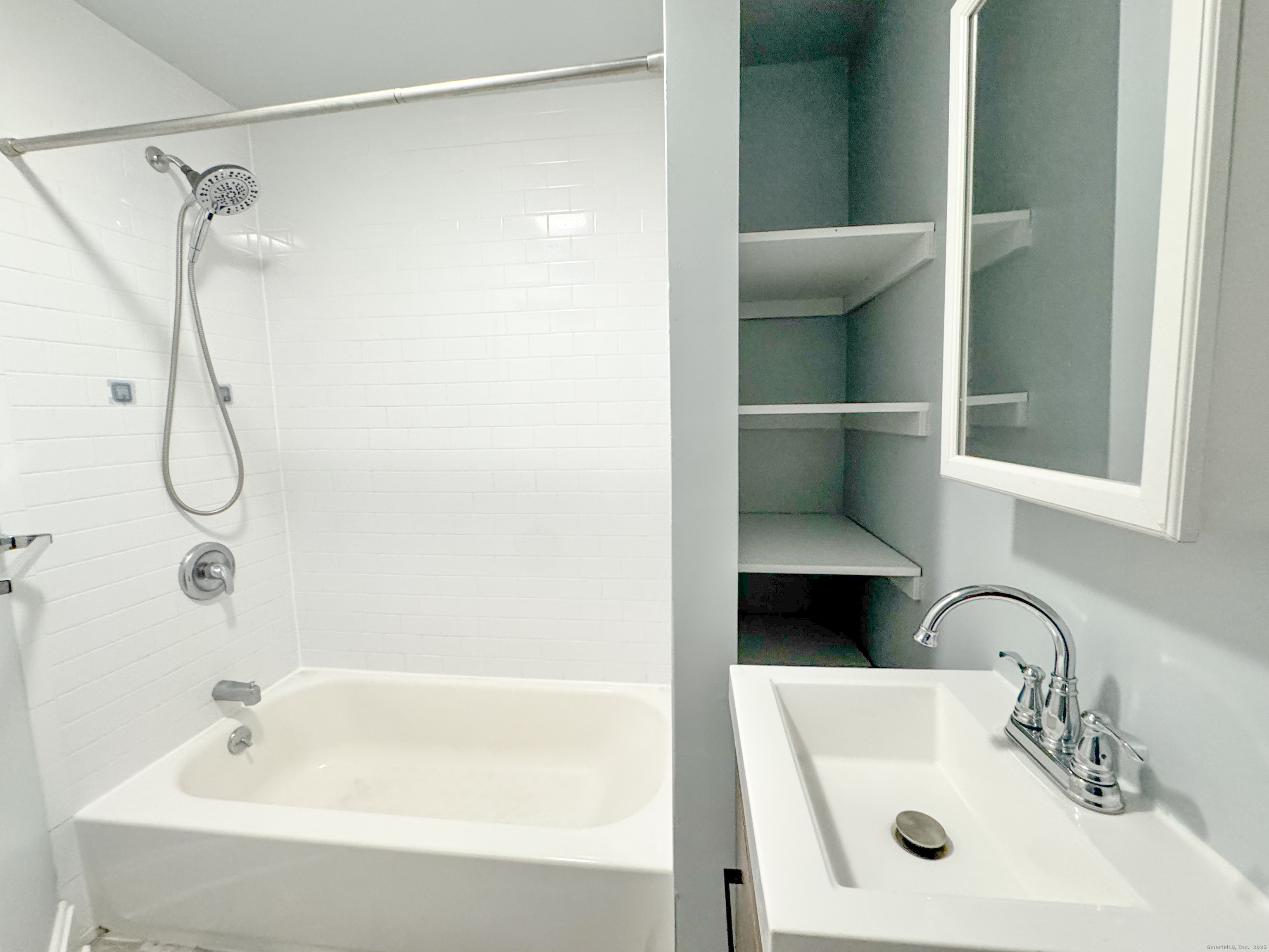 46 Riverside Drive Fairfield, CT 06824 - Photo 18 of 20 a bathroom with a sink and shower