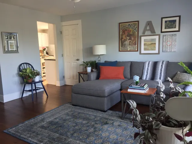 a living room with furniture and wooden floor