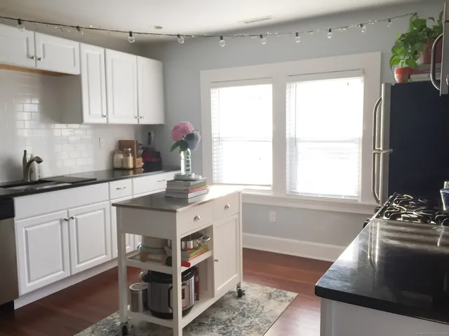a kitchen with a sink stove and cabinets