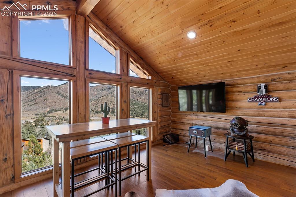 9110 Mountain Road Cascade, CO 80809 - Photo 19 of 49 a dining room with furniture windows and wooden floor