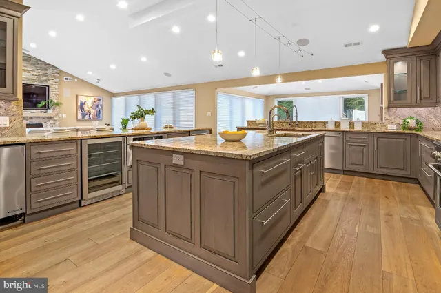 a kitchen with lots of counter top space sink and stainless steel appliances