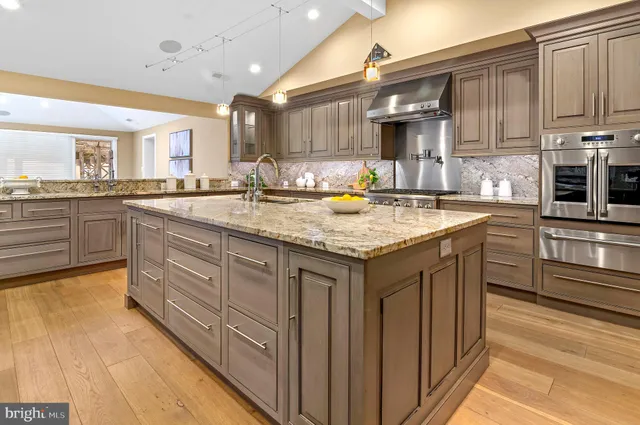 a kitchen with a sink stove and cabinets