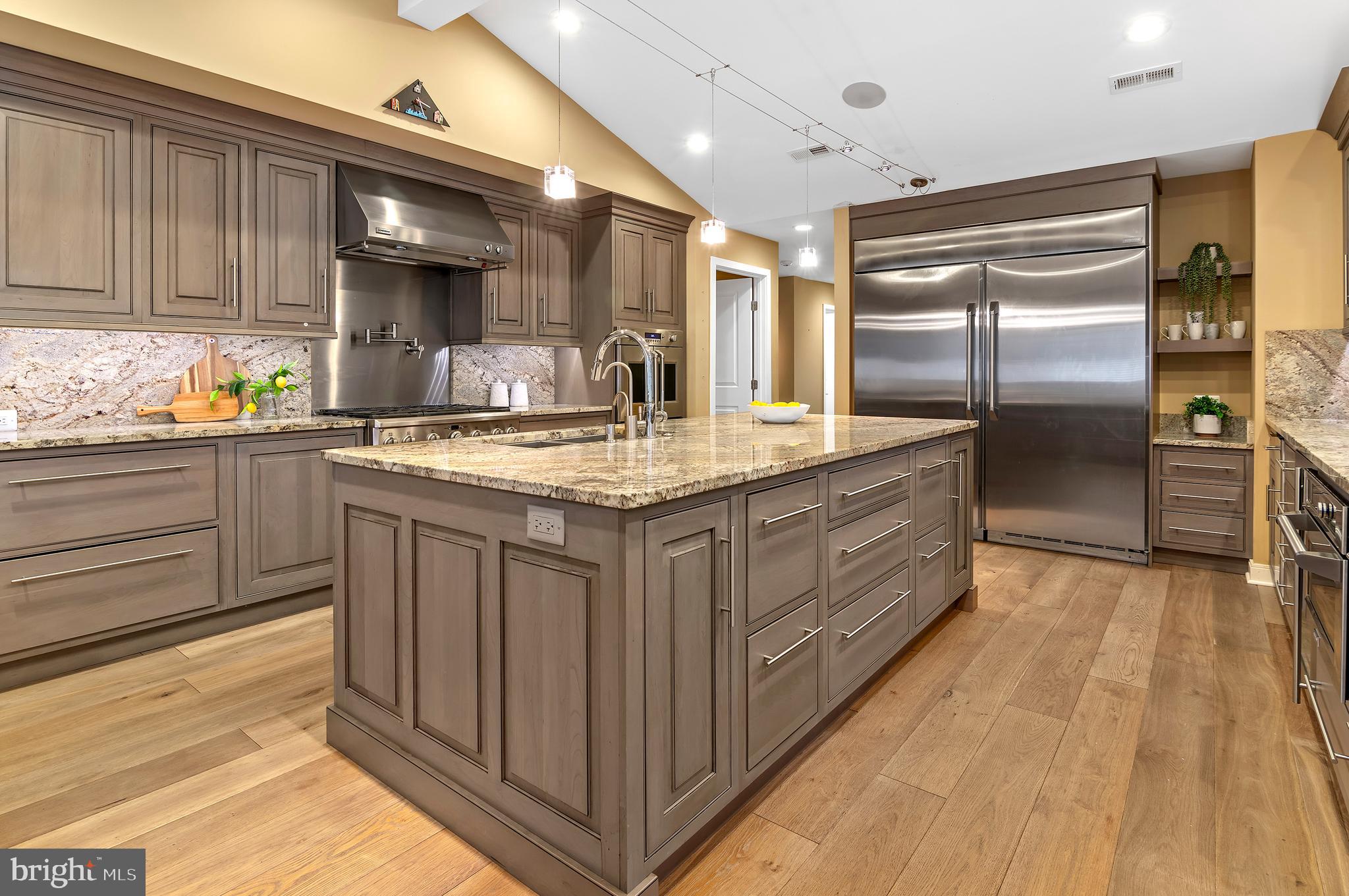 3521 Old Court Road Baltimore, MD 21208 - Photo 13 of 39 a kitchen with kitchen island granite countertop a sink cabinets and stainless steel appliances