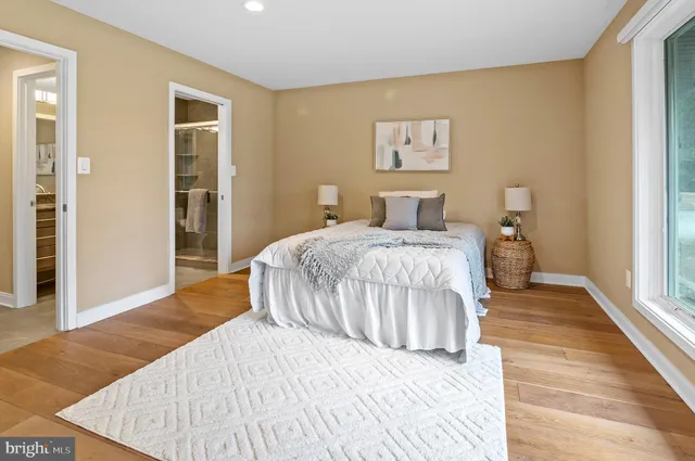 a bedroom with a large bed and a chandelier