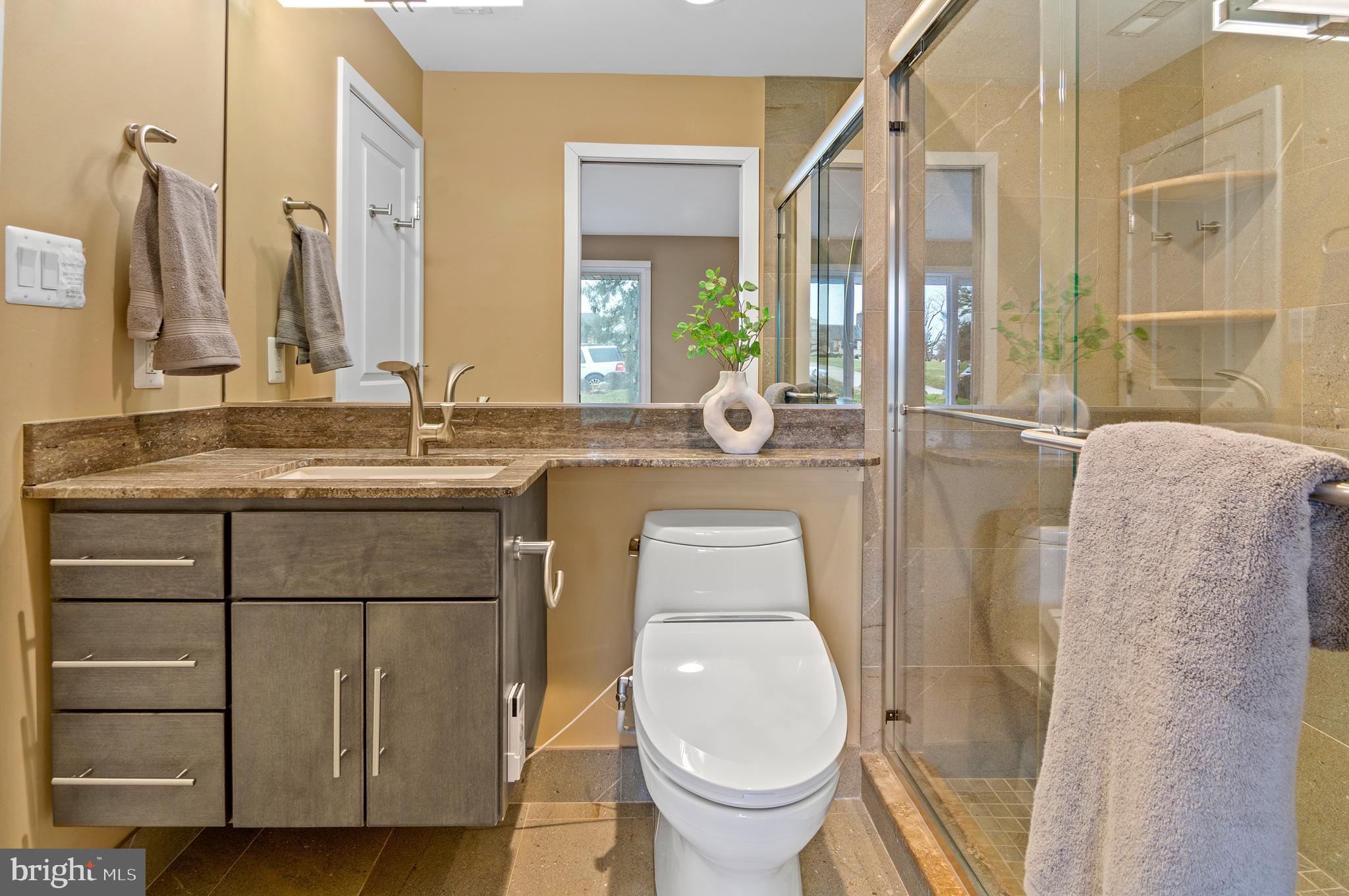 3521 Old Court Road Baltimore, MD 21208 - Photo 24 of 39 a bathroom with a granite countertop sink a toilet and a mirror