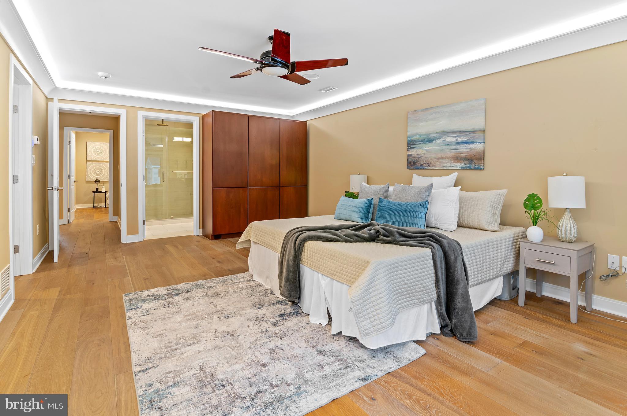 3521 Old Court Road Baltimore, MD 21208 - Photo 30 of 39 a bedroom with a large bed and a chandelier