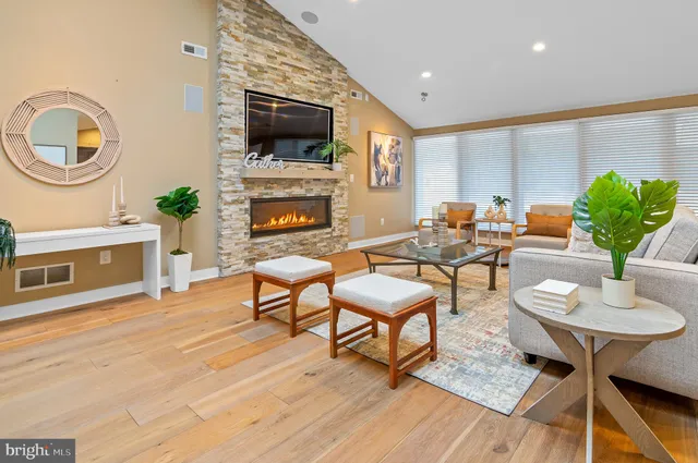 a living room with furniture a fireplace and a flat screen tv