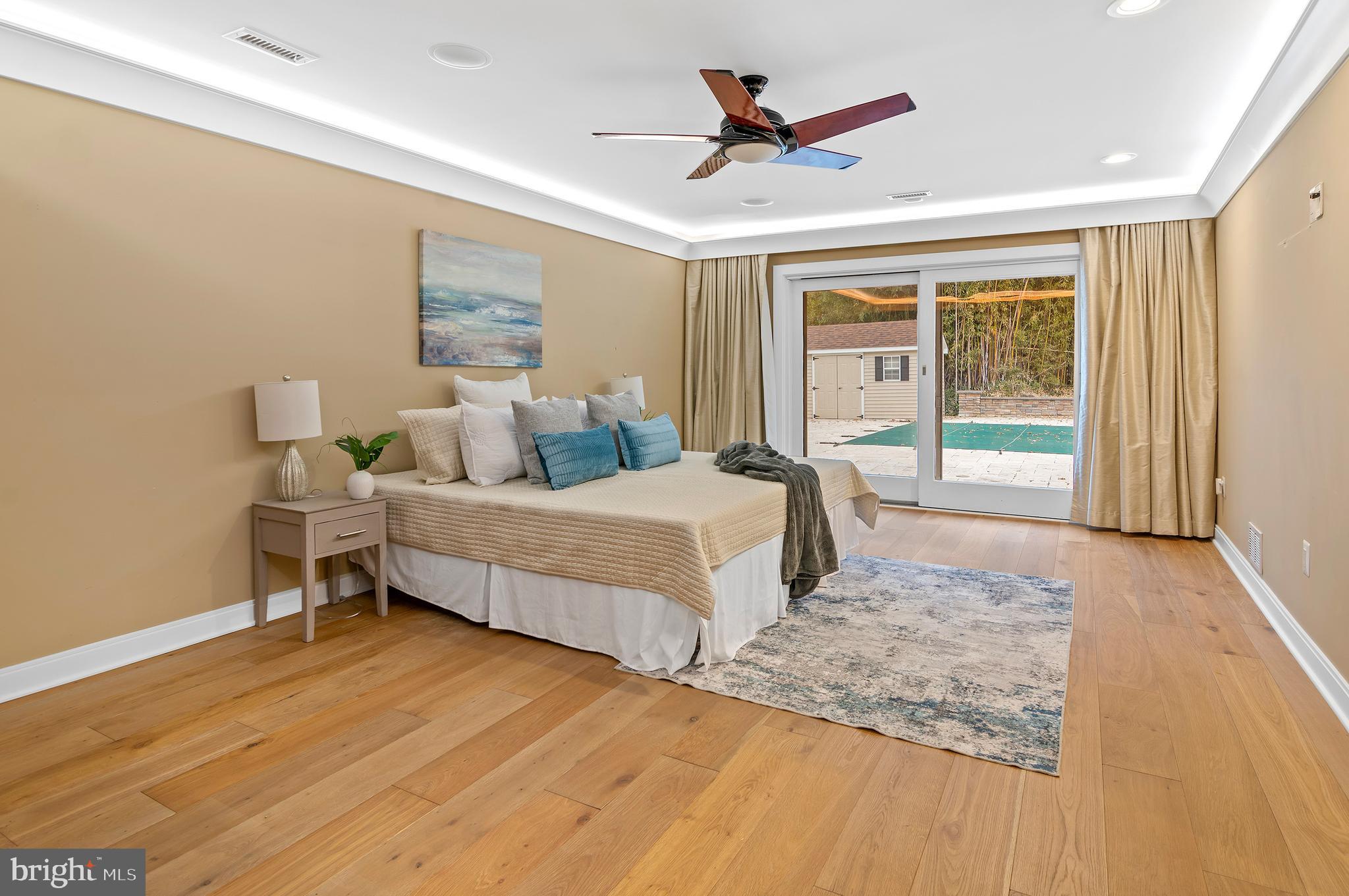 3521 Old Court Road Baltimore, MD 21208 - Photo 31 of 39 a spacious bedroom with a large bed and a large window