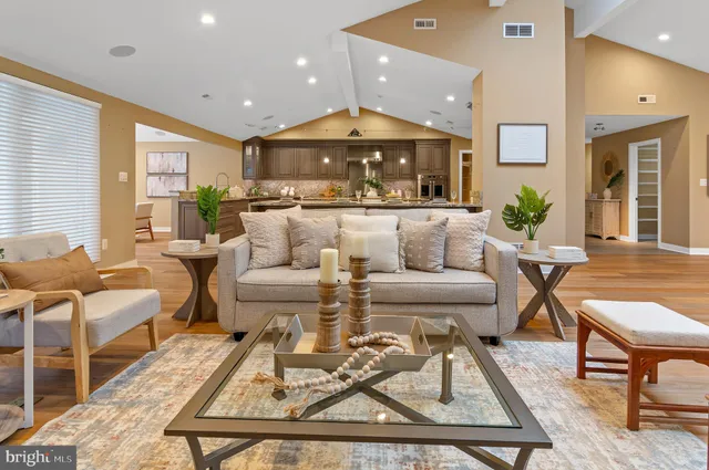 a living room with furniture and a chandelier