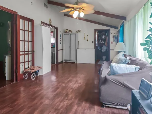 a living room with furniture and a wooden floor