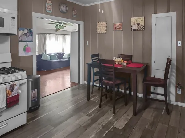 a view of a dining room with furniture and wooden floor