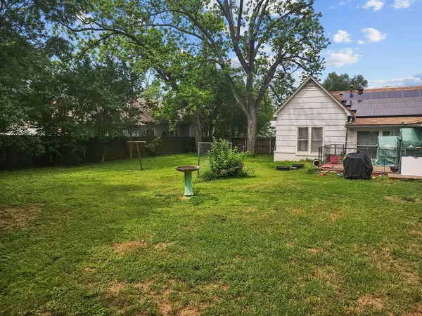 a house view with a play ground in front of it