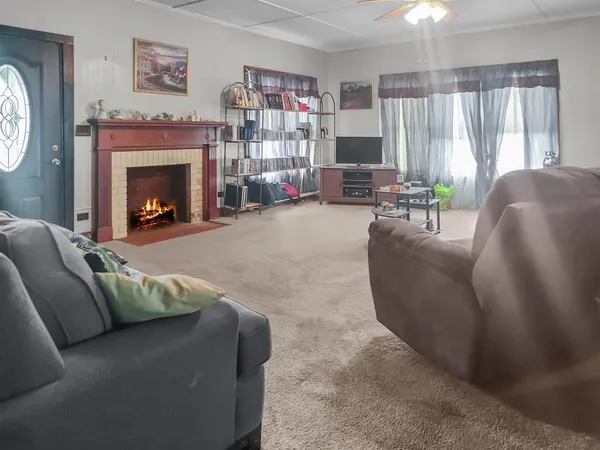 a living room with furniture and a fireplace
