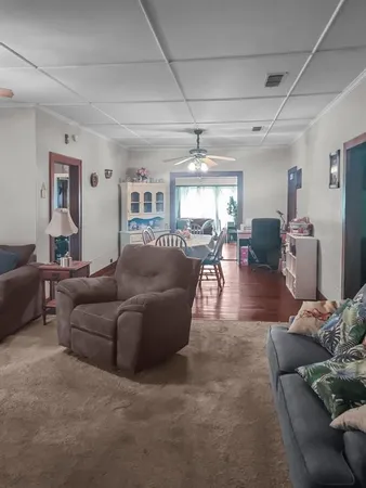 a living room with furniture and chandelier