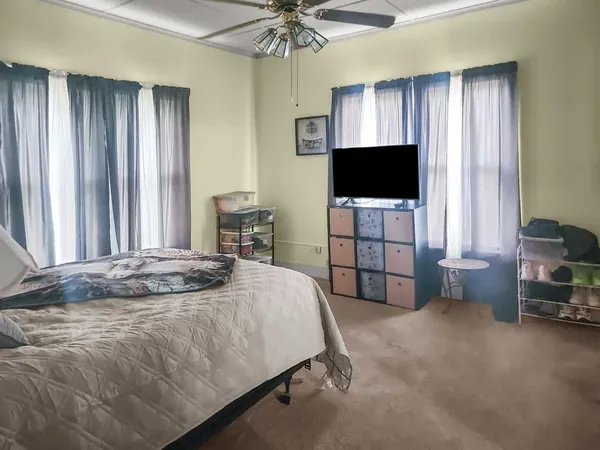 a bedroom with a bed and a television