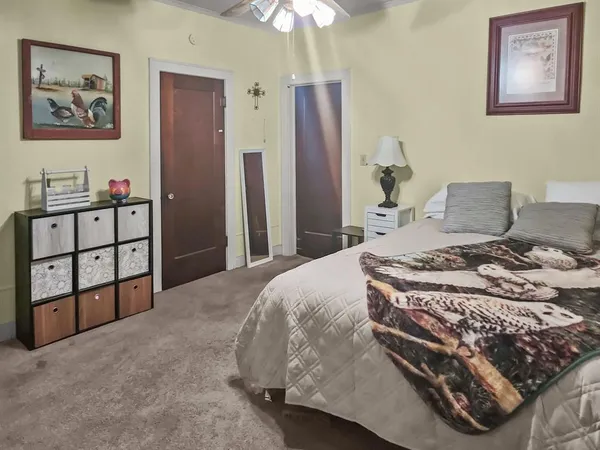 a bedroom with a bed and a chandelier