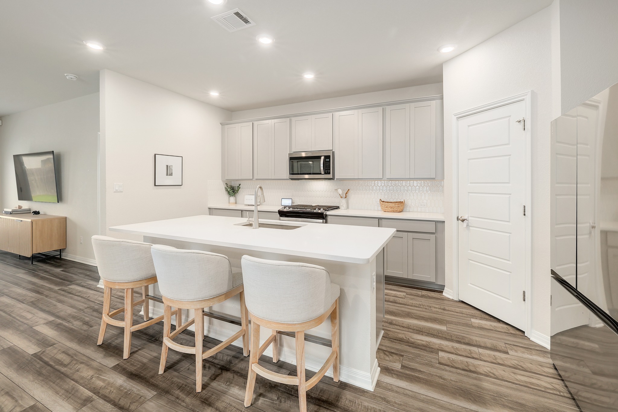 144 Sungrove Trail Georgetown, TX 78628 - Photo 6 of 40 The tastefully designed kitchen includes 42” cabinets, quartz counters and a large walk-in pantry