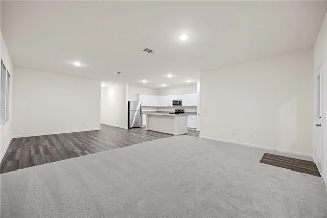 a view of kitchen and refrigerator
