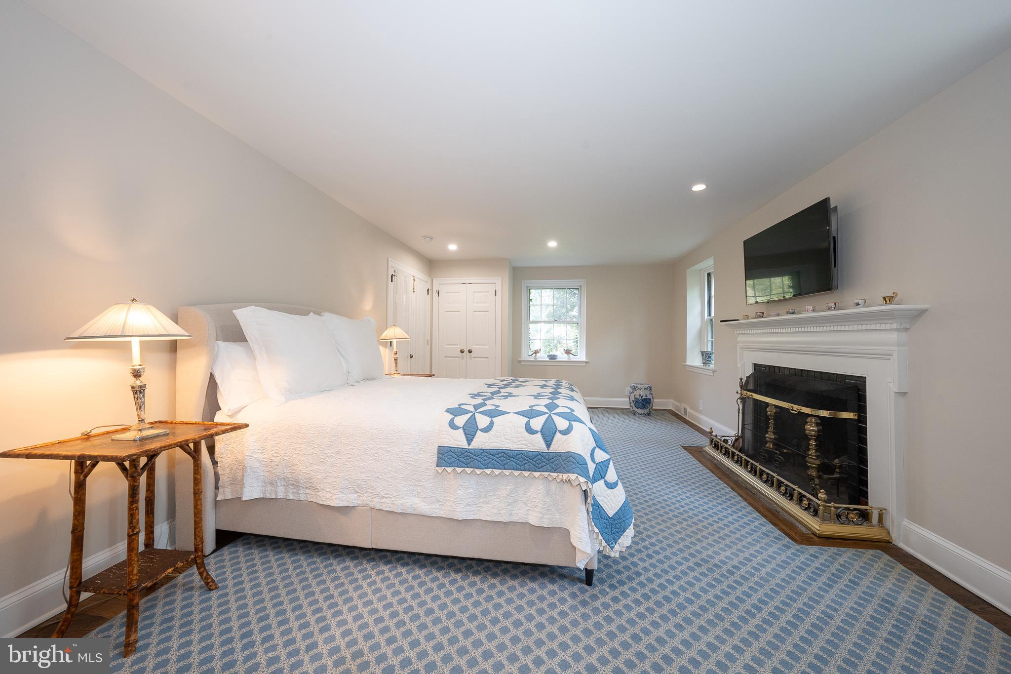 510 Lynmere Road Bryn Mawr, PA 19010 - Photo 20 of 44 a spacious bedroom with a bed and a fireplace