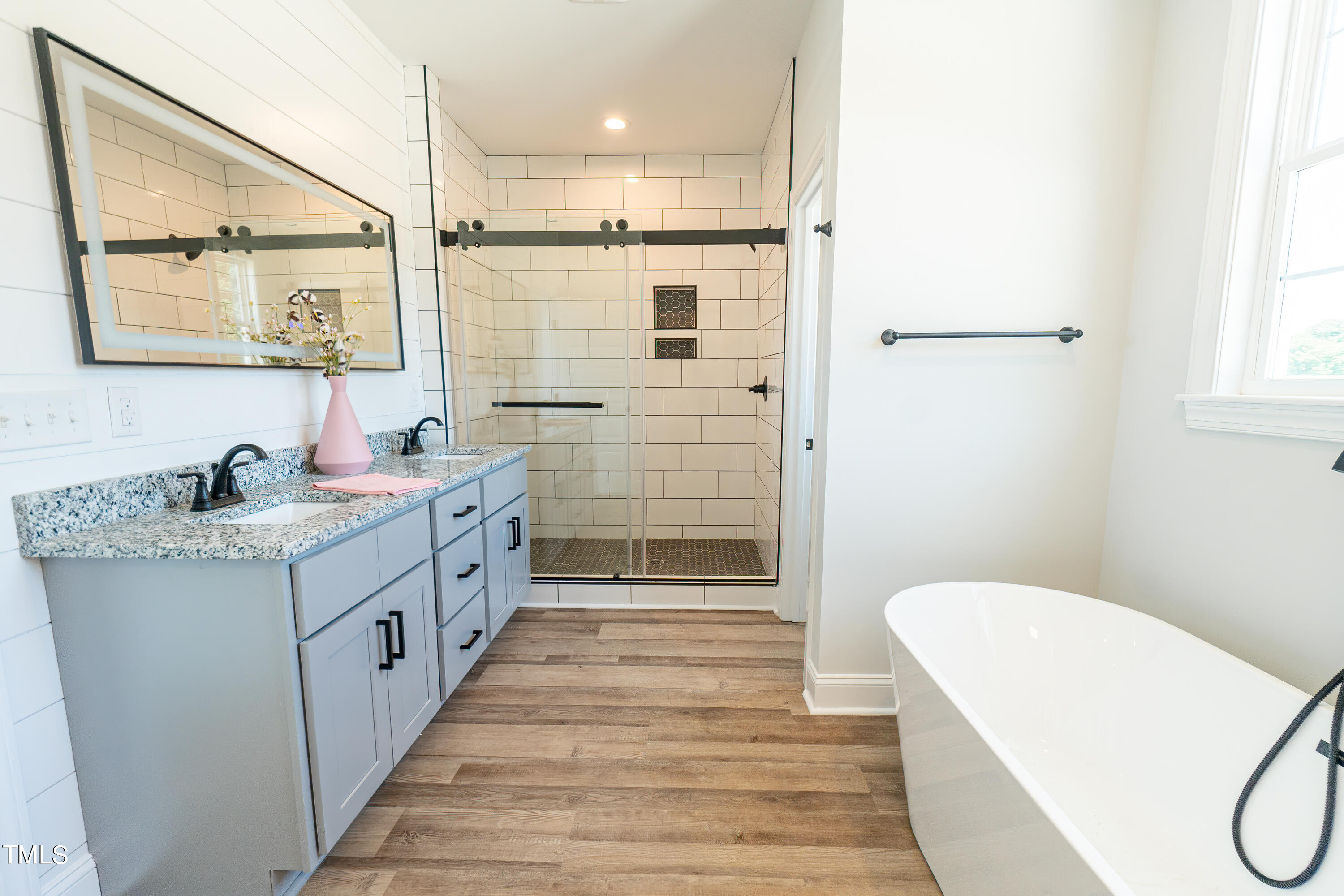 6591 Green Path Road Dunn, NC 28334 - Photo 14 of 25 a bathroom with a granite countertop sink a toilet a mirror and shower