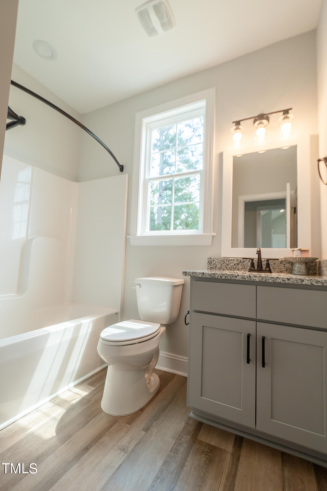 6591 Green Path Road Dunn, NC 28334 - Photo 22 of 25 a bathroom with a sink toilet a mirror and vanity