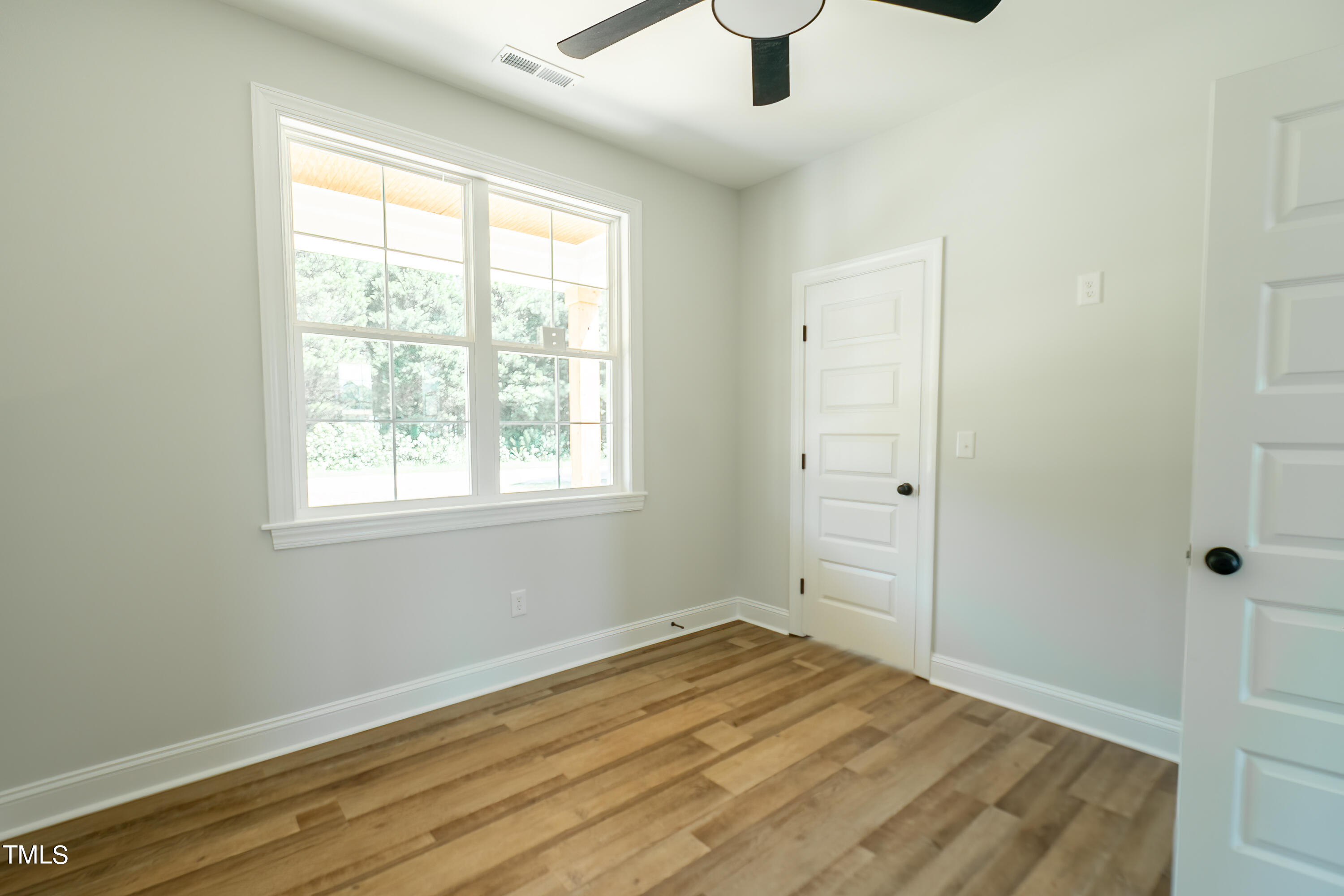 6591 Green Path Road Dunn, NC 28334 - Photo 23 of 25 a view of empty room with wooden floor and fan