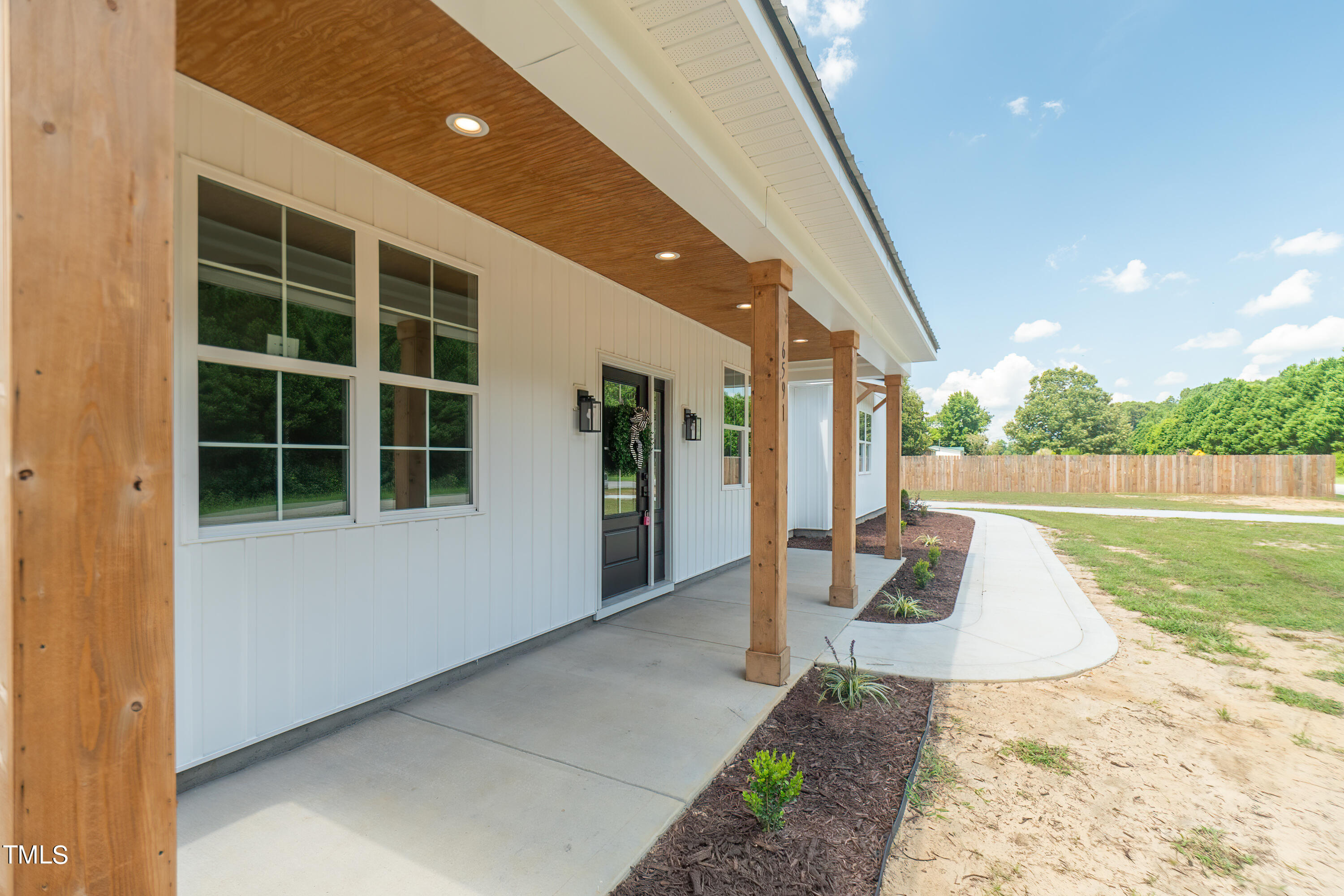 6591 Green Path Road Dunn, NC 28334 - Photo 3 of 25 a view of a house with a yard and potted plants