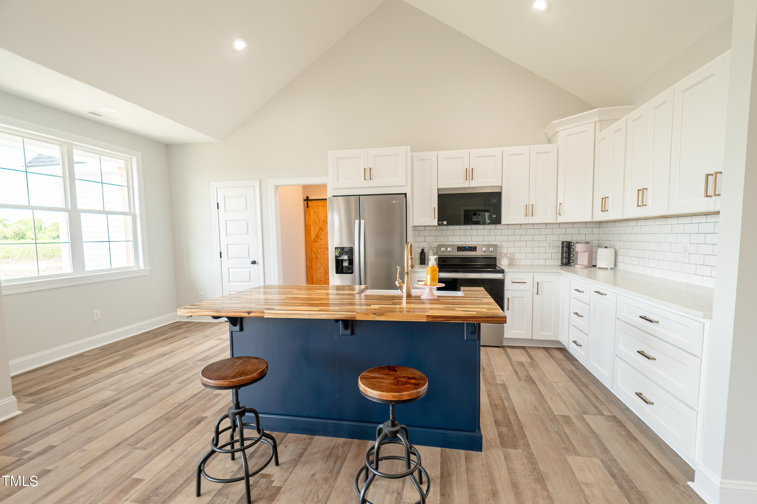 6591 Green Path Road Dunn, NC 28334 - Photo 6 of 25 a kitchen with stainless steel appliances a stove a sink dishwasher and a refrigerator with wooden floor