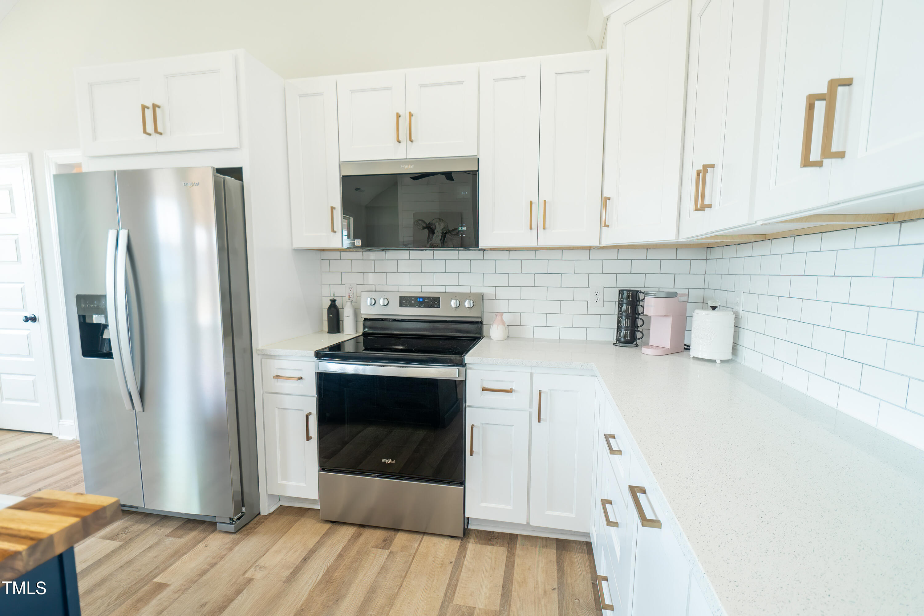 6591 Green Path Road Dunn, NC 28334 - Photo 7 of 25 a kitchen with stainless steel appliances a stove microwave and refrigerator