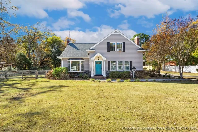 a view of a house with swimming pool and a yard