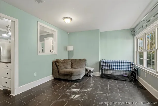 a view of a hallway with dining room and wooden floor
