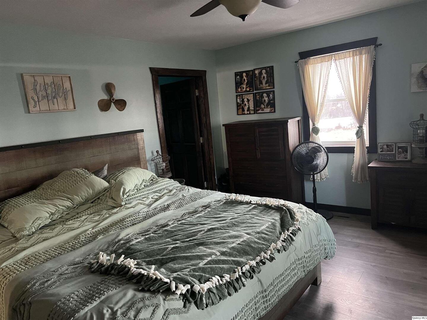 1126 East Co Road 350 Sutter, IL 62373 - Photo 8 of 23 a bedroom with a bed and wooden floor