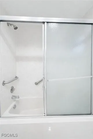 a bathroom with a shower and a bath tub