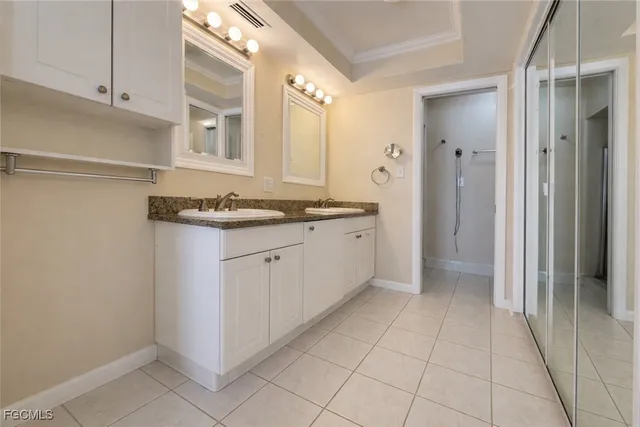 a view of a kitchen with white cabinets