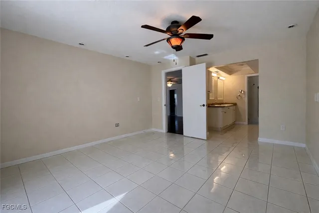 an empty room with a space and a ceiling fan