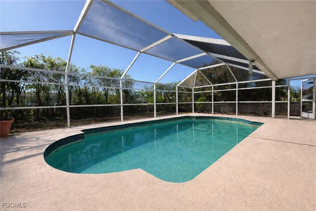 a view of a swimming pool with a yard