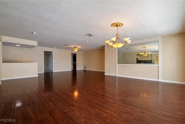 a view of a room with wooden floor