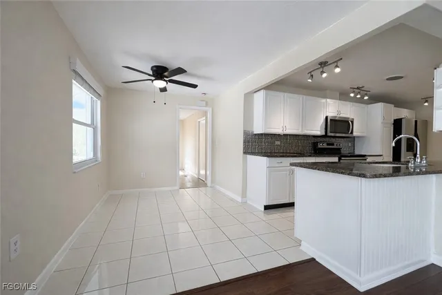 a view of kitchen with granite countertop cabinets and a stove