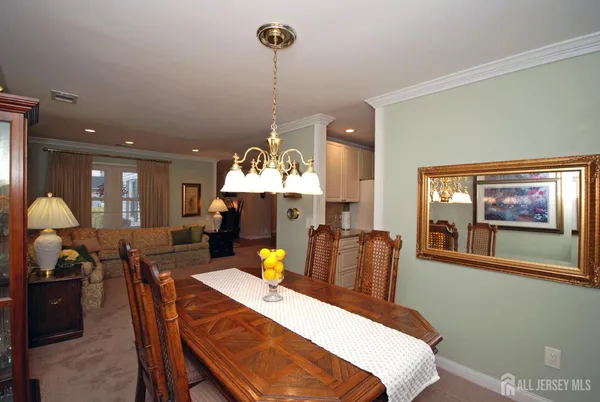 a view of a dining room with furniture and chandelier
