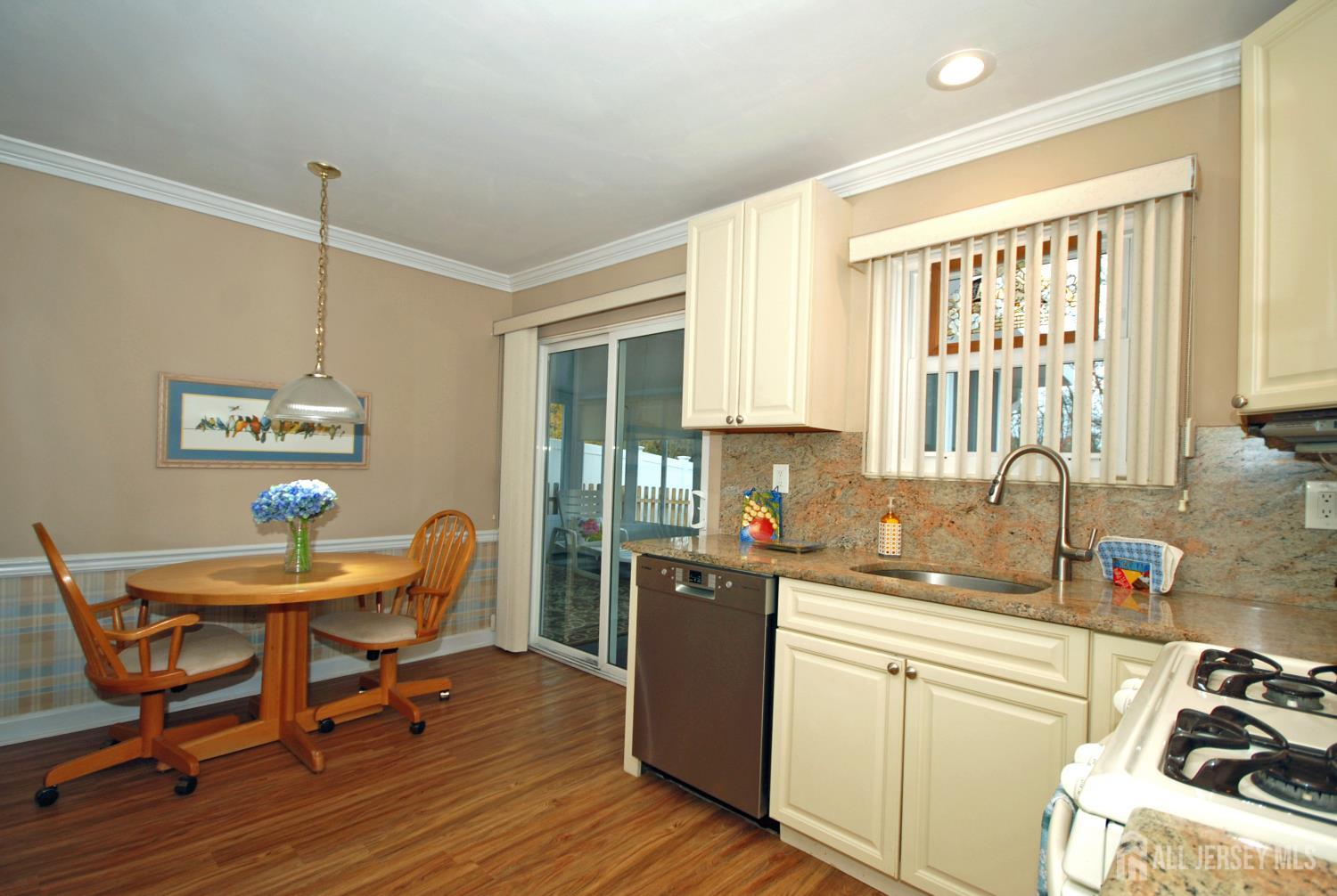 26 Sunshine Lane Edison, NJ 08820 - Photo 14 of 33 a kitchen with a table chairs refrigerator and sink