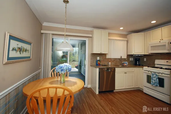 a kitchen with stainless steel appliances granite countertop a stove and a refrigerator
