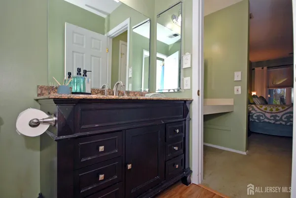 a bathroom with a sink a vanity and a mirror
