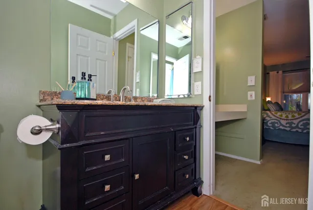 a bathroom with a sink a vanity and a mirror