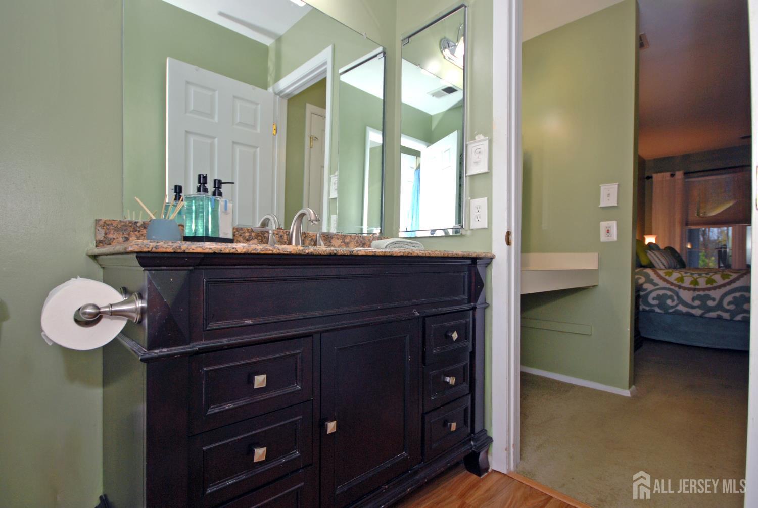 26 Sunshine Lane Edison, NJ 08820 - Photo 18 of 33 a bathroom with a sink a vanity and a mirror